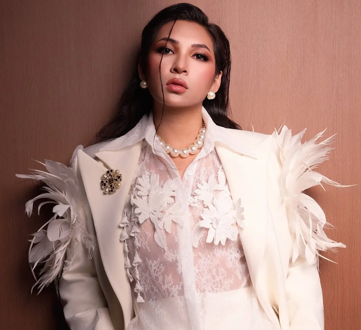 Tiffany Nghi La in a white feather blazer and pearls — editorial portrait